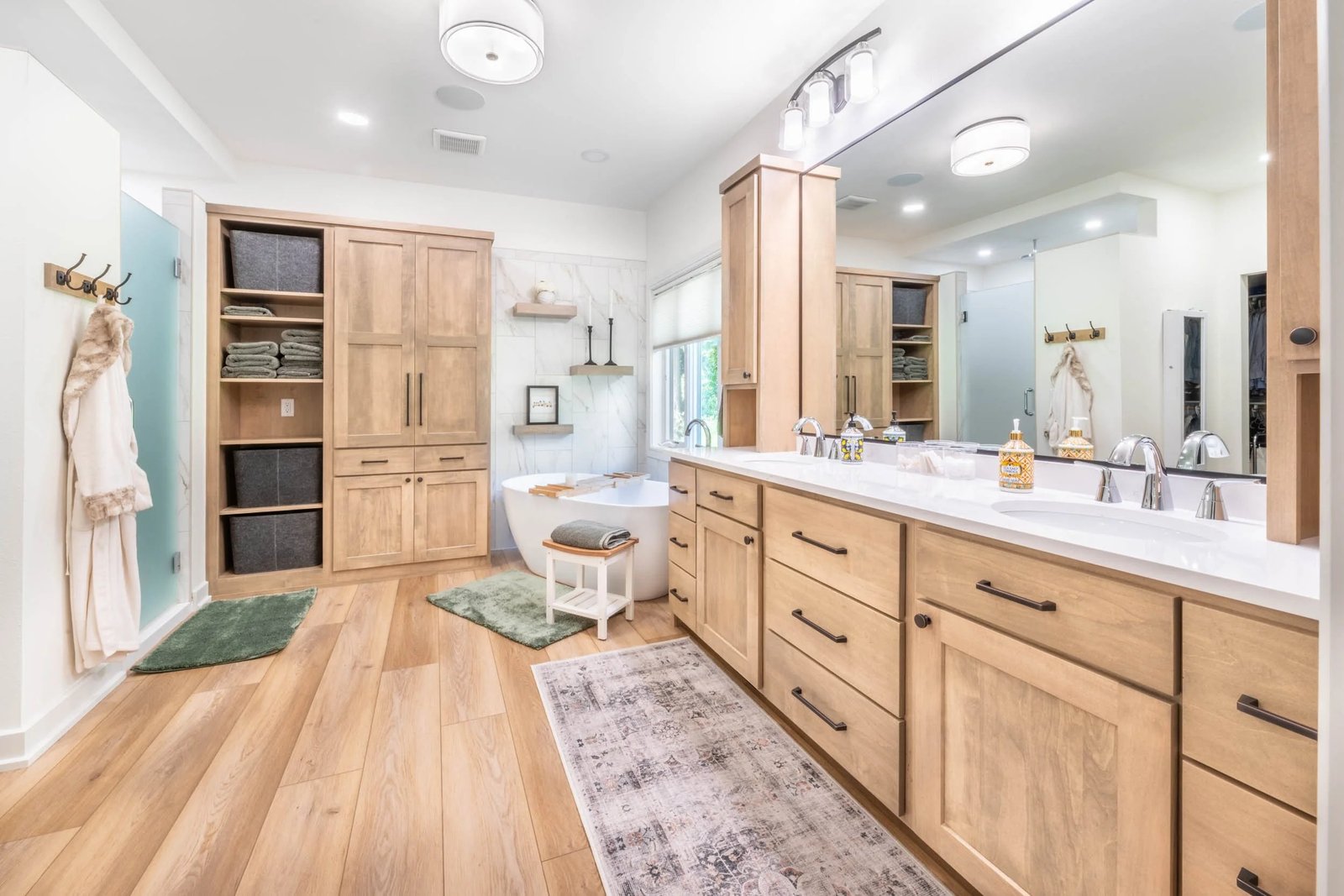 Modern bathroom remodeling with custom wood vanity, freestanding tub, and luxury finishes